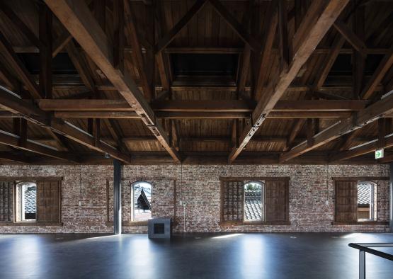 a room with brick walls and wooden beams