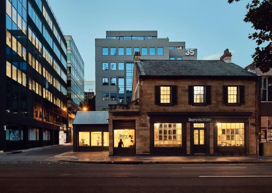 a building with windows and a street in the background