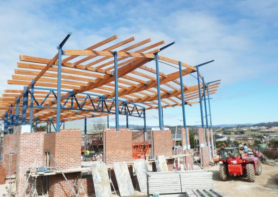 a construction site with a red tractor and a blue sky