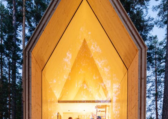 a triangular shaped house with a large window