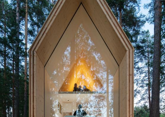 a wooden house with a triangular shaped window