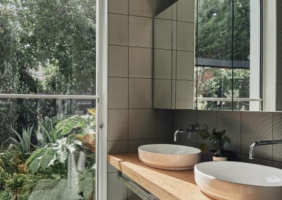 a bathroom with double sinks and a large window