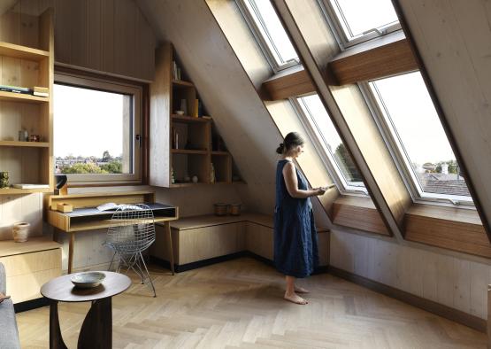 a woman standing in a room with a window