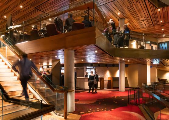 a group of people walking up stairs in a building