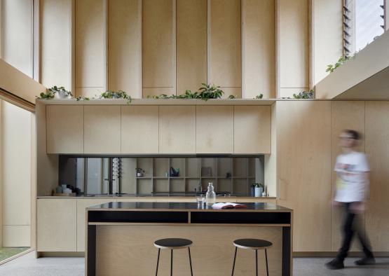 a person walking in a kitchen