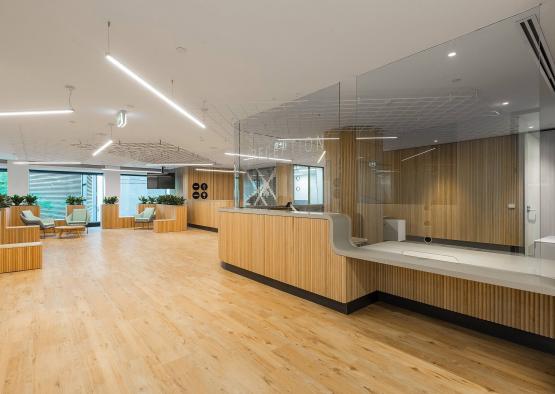 a room with a reception desk and chairs