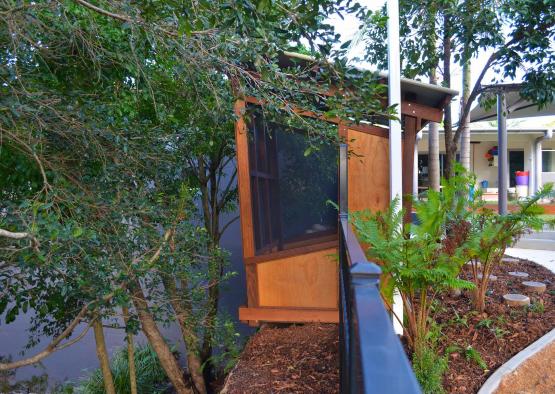 a small wooden structure with a screen door