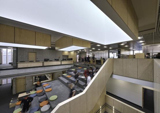 a group of people walking up stairs in a building