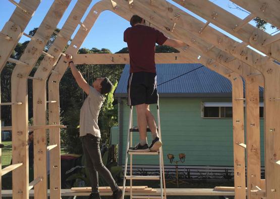 two men on a ladder in a frame