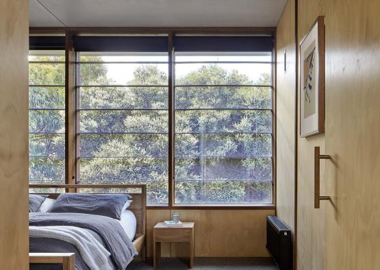 a bedroom with a bed and a window