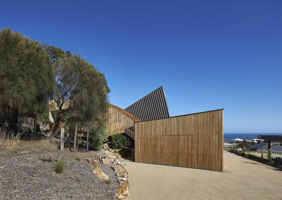 a building with a wooden fence and trees