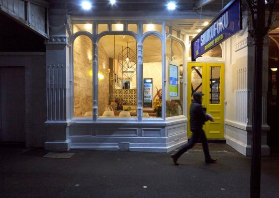 a man walking past a restaurant