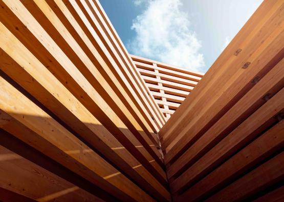 a wood structure with blue sky and clouds