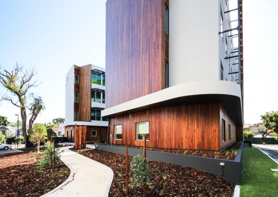 a building with a walkway and grass