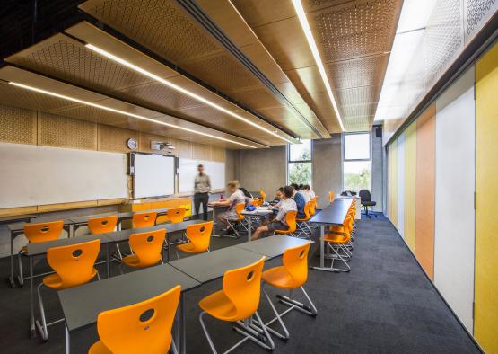 a classroom with many tables and chairs