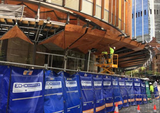 a man on a lift working on a building under construction