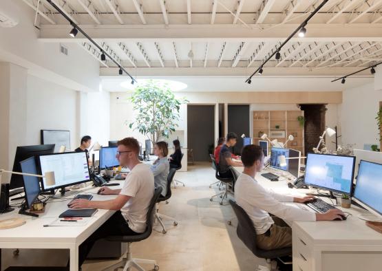 a group of people sitting at computers