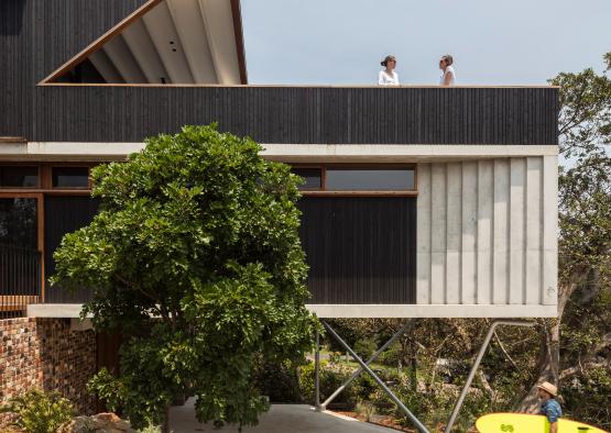 a person with a surfboard on a balcony