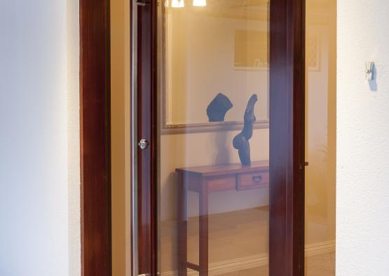 a glass door with a desk and a table