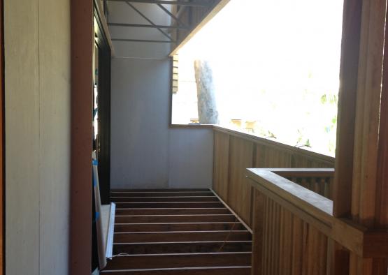 a wooden stairs leading to a porch