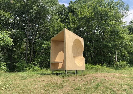 a wooden structure in a grassy area