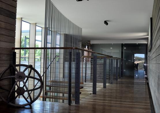 a hallway with a wooden floor and railing