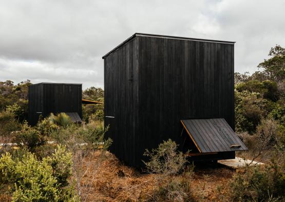 a black building in a field