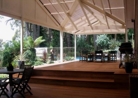 a patio with a deck and chairs