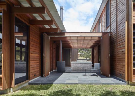 a patio with a chair and a brick wall