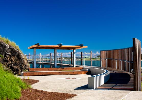 a walkway with a wooden structure and a fence