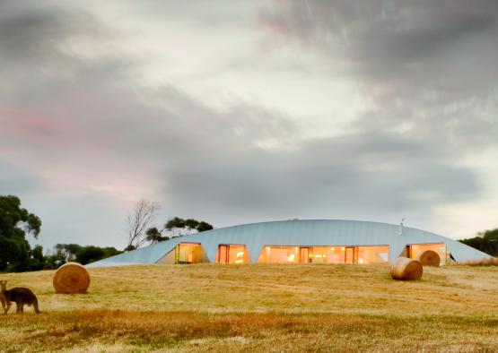 a building with bales of hay in front of it