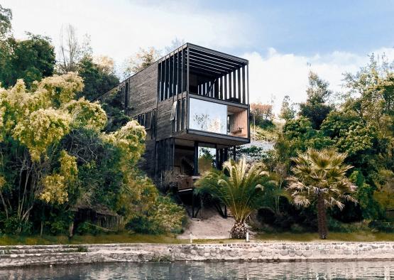 a building with a glass roof surrounded by trees