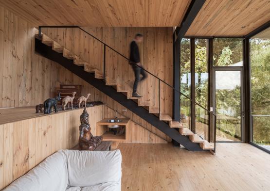 a man walking up a staircase in a house