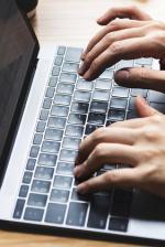 hands typing on a keyboard