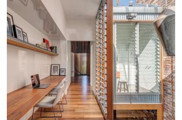 a room with a desk and a wood floor