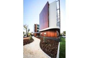 a building with a walkway and grass