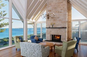 a living room with a fireplace and chairs