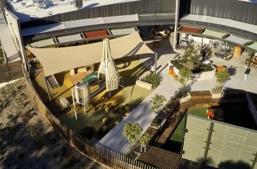 a playground with a fence and a building