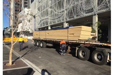 a truck with a large stack of wood on it