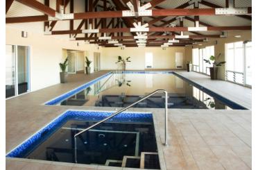 a indoor swimming pool with a metal railing