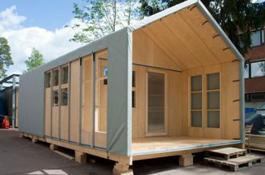 a wooden house with a grey cover