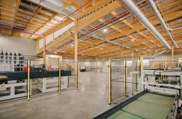 a large room with a large metal fence and a large metal pipe