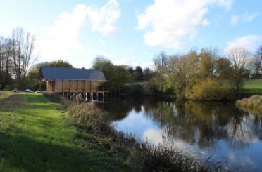 a building on a dock by a lake