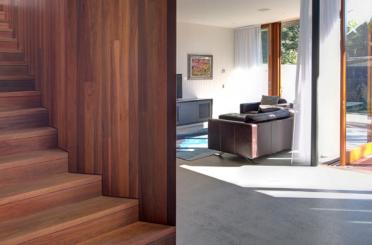 a living room with a wood staircase and a couch