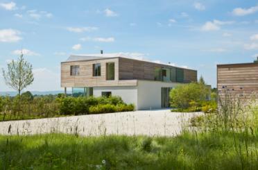 a house with a gravel driveway and bushes