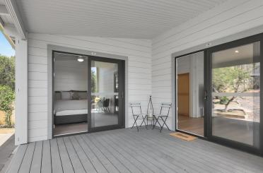 a patio with a bed and chairs